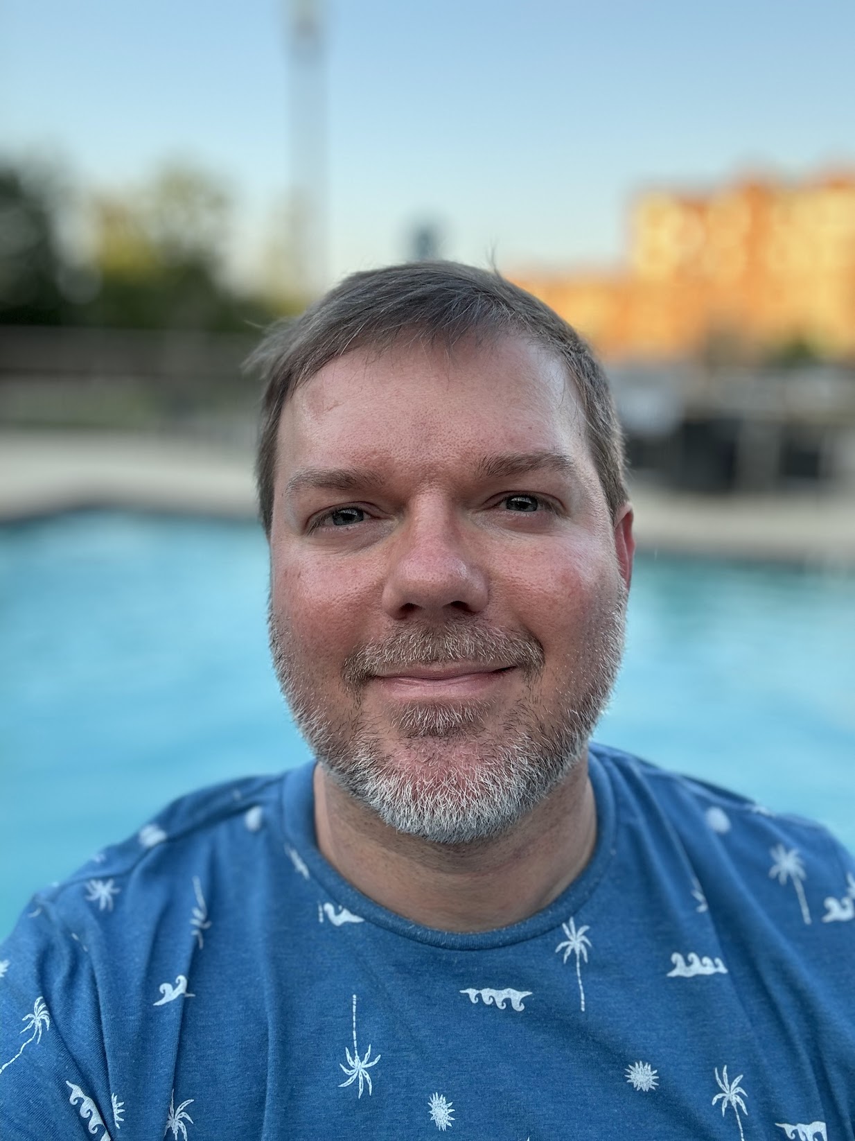 a man with a beard and a blue shirt