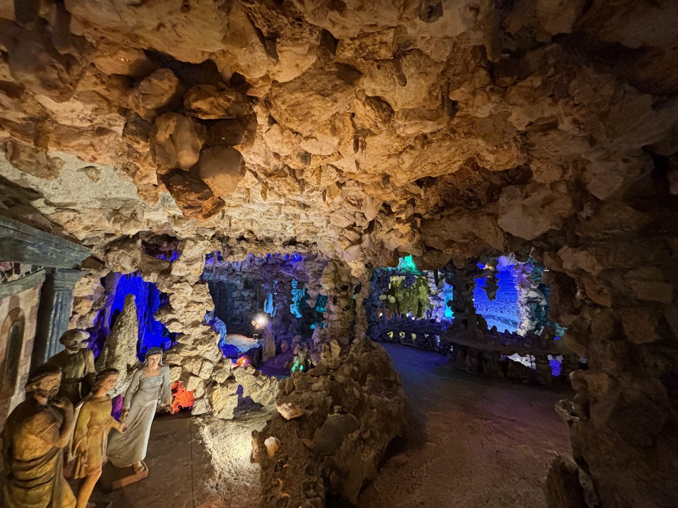 a cave with statues and rocks