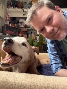 a man taking a selfie with a dog